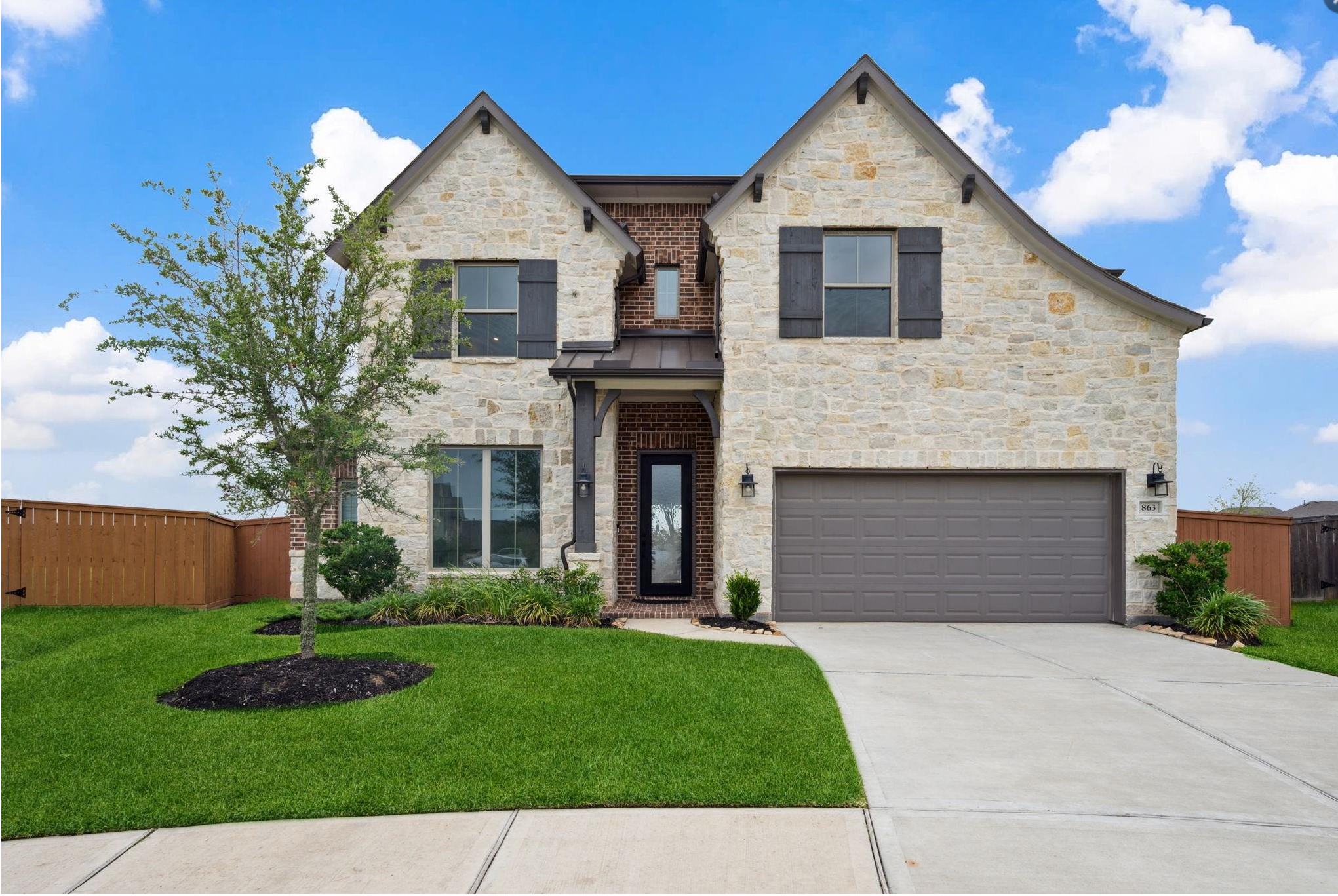 alt="Beautiful modern two-story home with manicured lawn, listed by Sucré Realty"